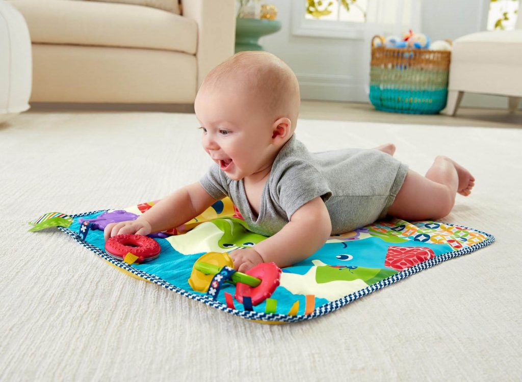 Baby crawling on a rug.
