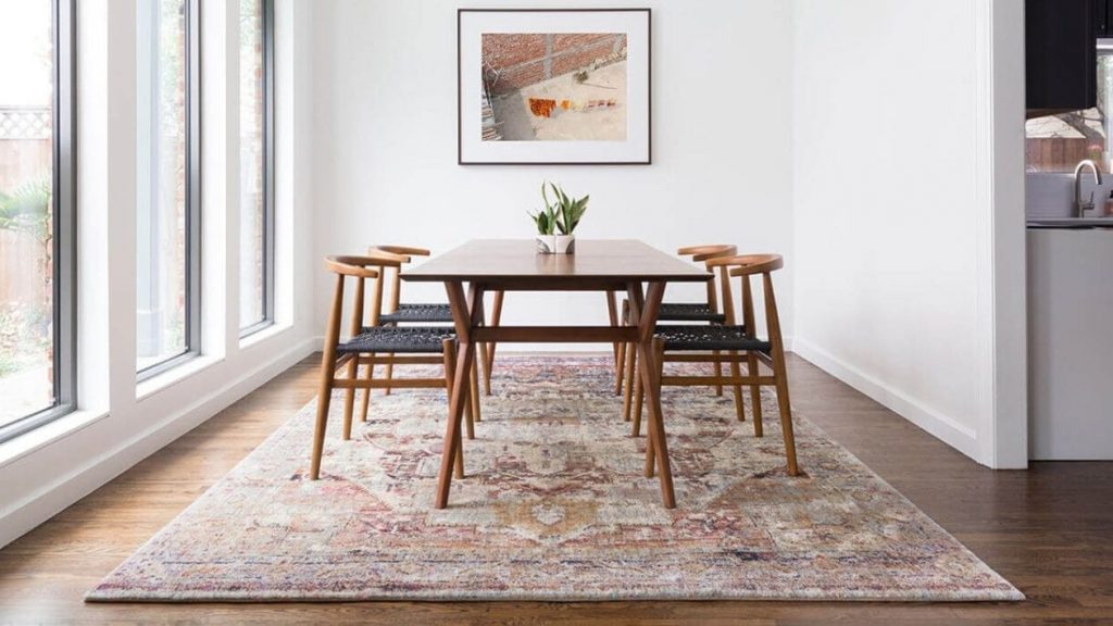 You want to put a rug in places where furniture or high-traffic can damage hardwood floor.