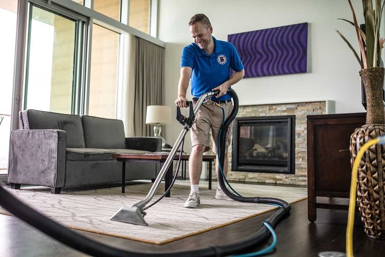 Professional cleaner cleaning wool rug.