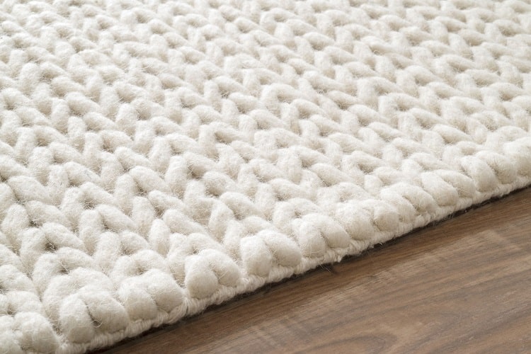White braided woolen rug.
