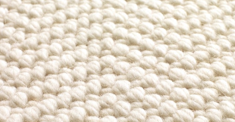 White wool braided rug.